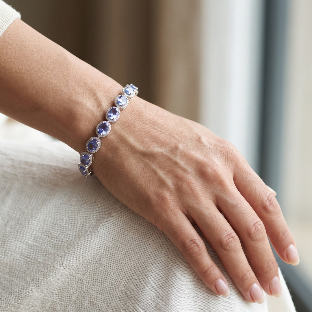 Tanzanite and natural diamond halo bracelet in 14K white gold worn on a wrist / צמיד טנזנייט ויהלומים בזהב לבן 14K על פרק היד