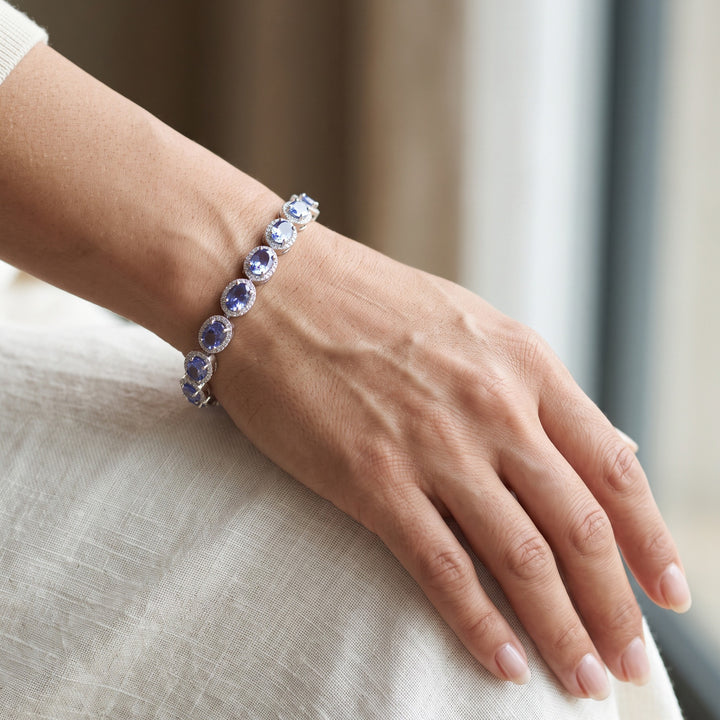 Tanzanite and natural diamond halo bracelet in 14K white gold worn on a wrist / צמיד טנזנייט ויהלומים בזהב לבן 14K על פרק היד