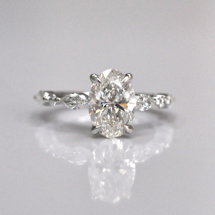 Oval Center Diamond with marquise &amp; Round side diamonds ring