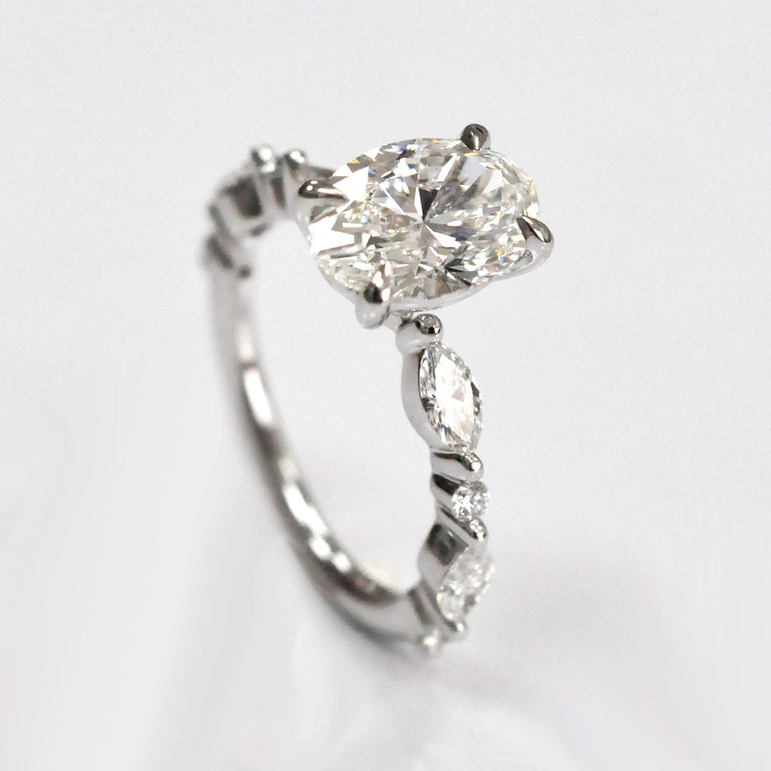Oval Center Diamond with marquise &amp; Round side diamonds ring