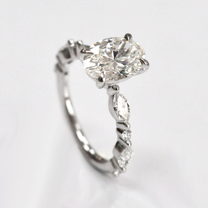 Oval Center Diamond with marquise &amp; Round side diamonds ring