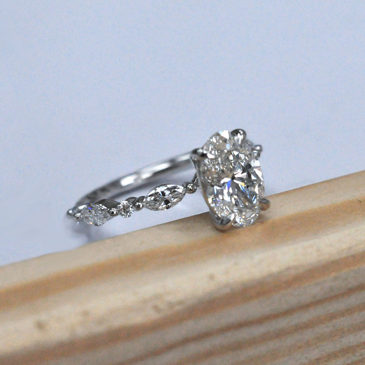Oval Center Diamond with marquise &amp; Round side diamonds ring