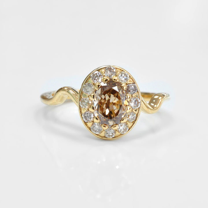 Oval Diamond and Halo twisted shank yellow gold Ring