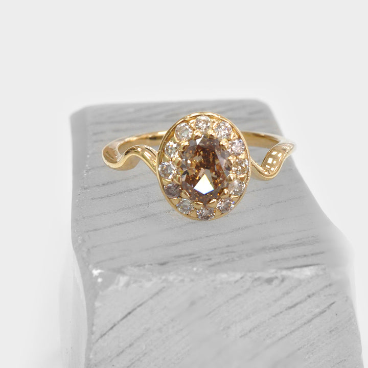 Oval Diamond and Halo twisted shank yellow gold Ring