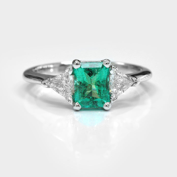 Natural Emerald and Two Side Trilliant Diamonds Ring