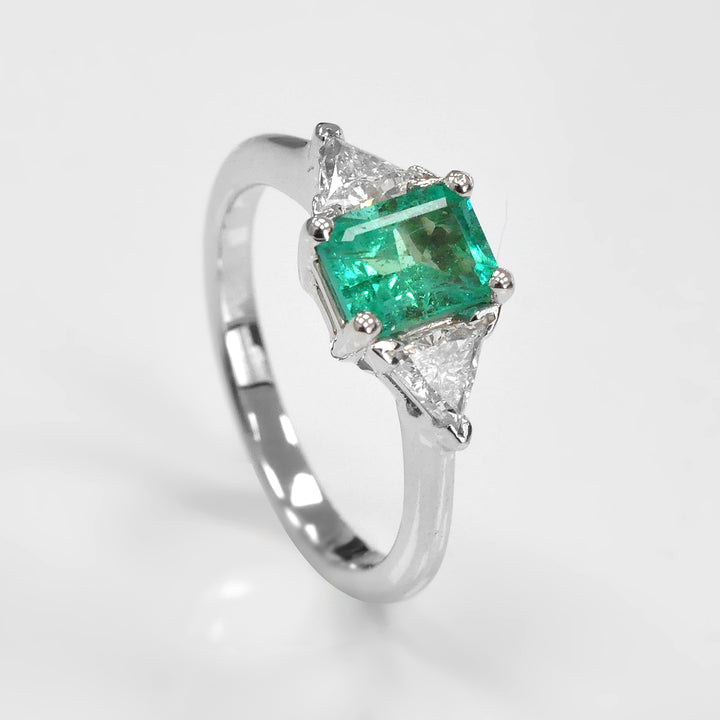 Natural Emerald and Two Side Trilliant Diamonds Ring