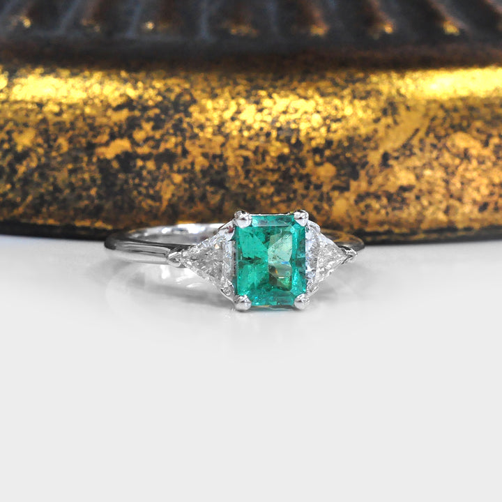 Natural Emerald and Two Side Trilliant Diamonds Ring