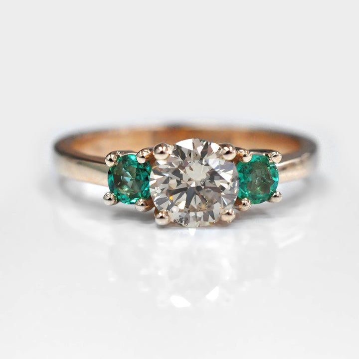 Round Diamond and Pair of Green Emeralds Ring