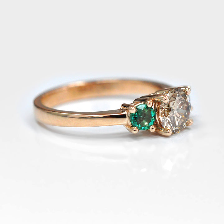Round Diamond and Pair of Green Emeralds Ring