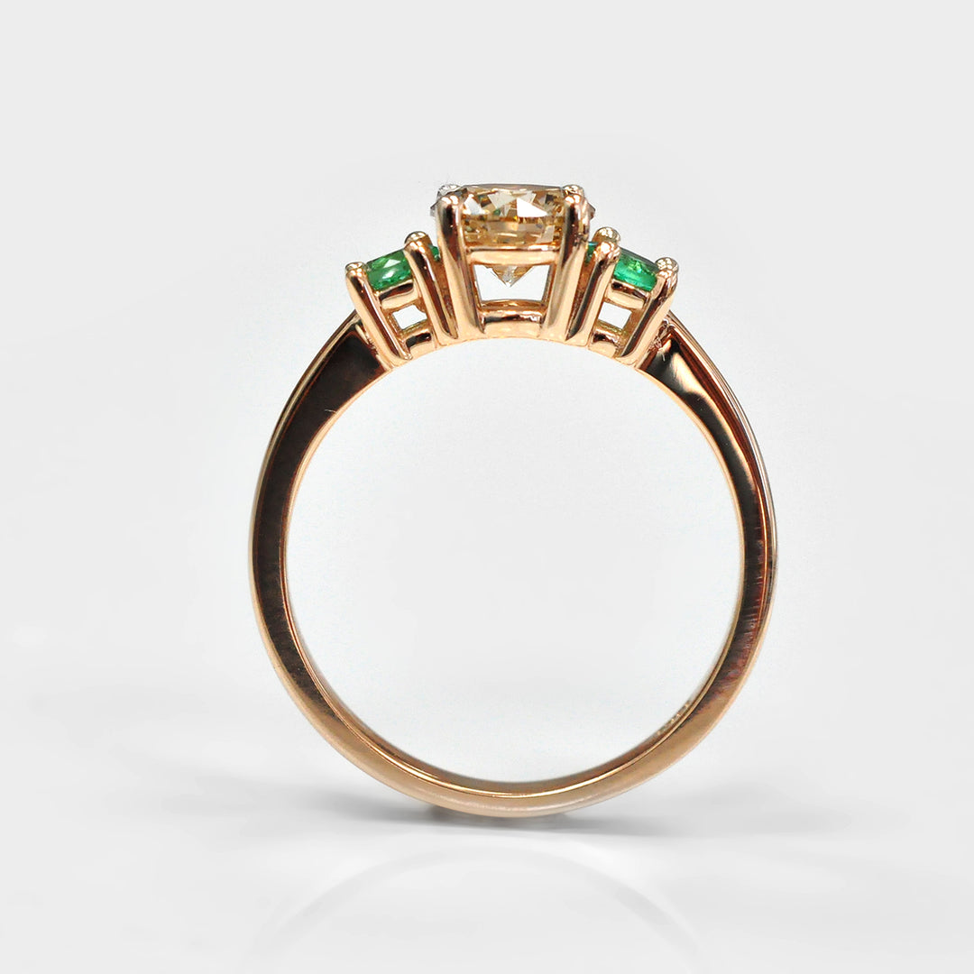 Round Diamond and Pair of Green Emeralds Ring