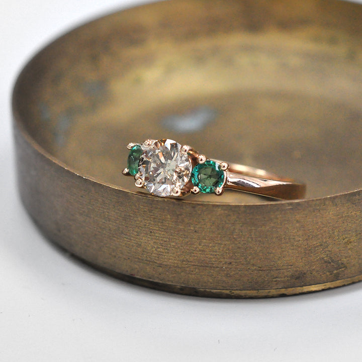 Round Diamond and Pair of Green Emeralds Ring