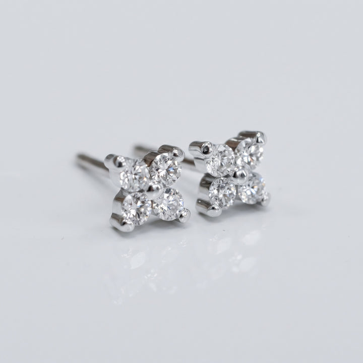 Delicate natural diamond flower stud earrings in 14K white gold — angled view