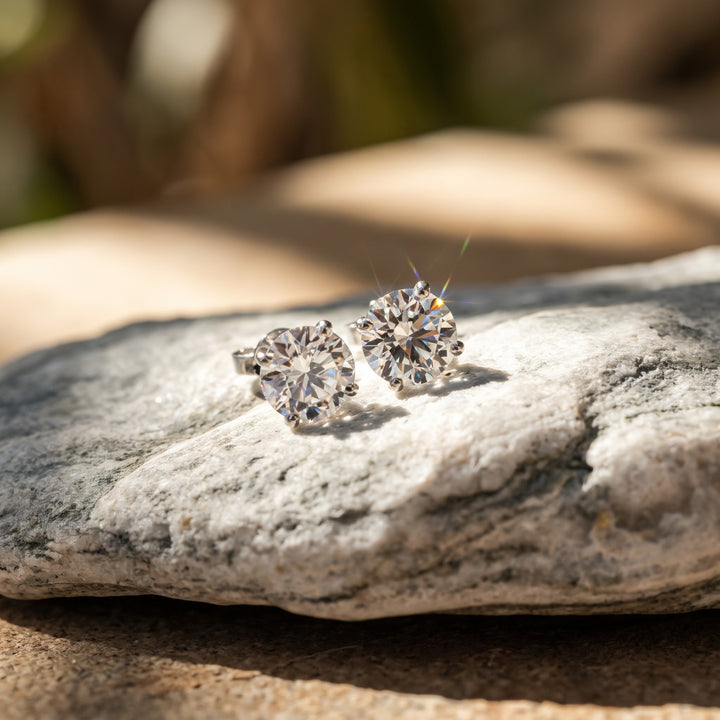 Lightweight martini natural diamond stud earrings in 14K white gold — pair in sunlight