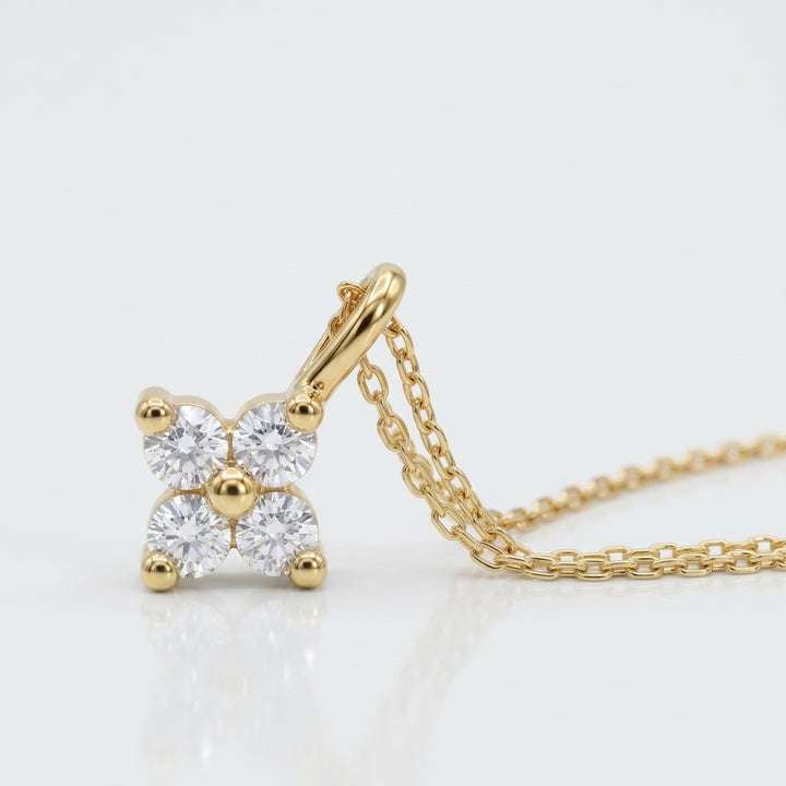 Four natural diamond flower pendant in 14K yellow gold with chain — close-up