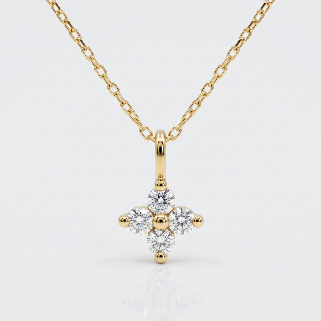Delicate four natural diamond flower pendant in 14K yellow gold with chain — front view