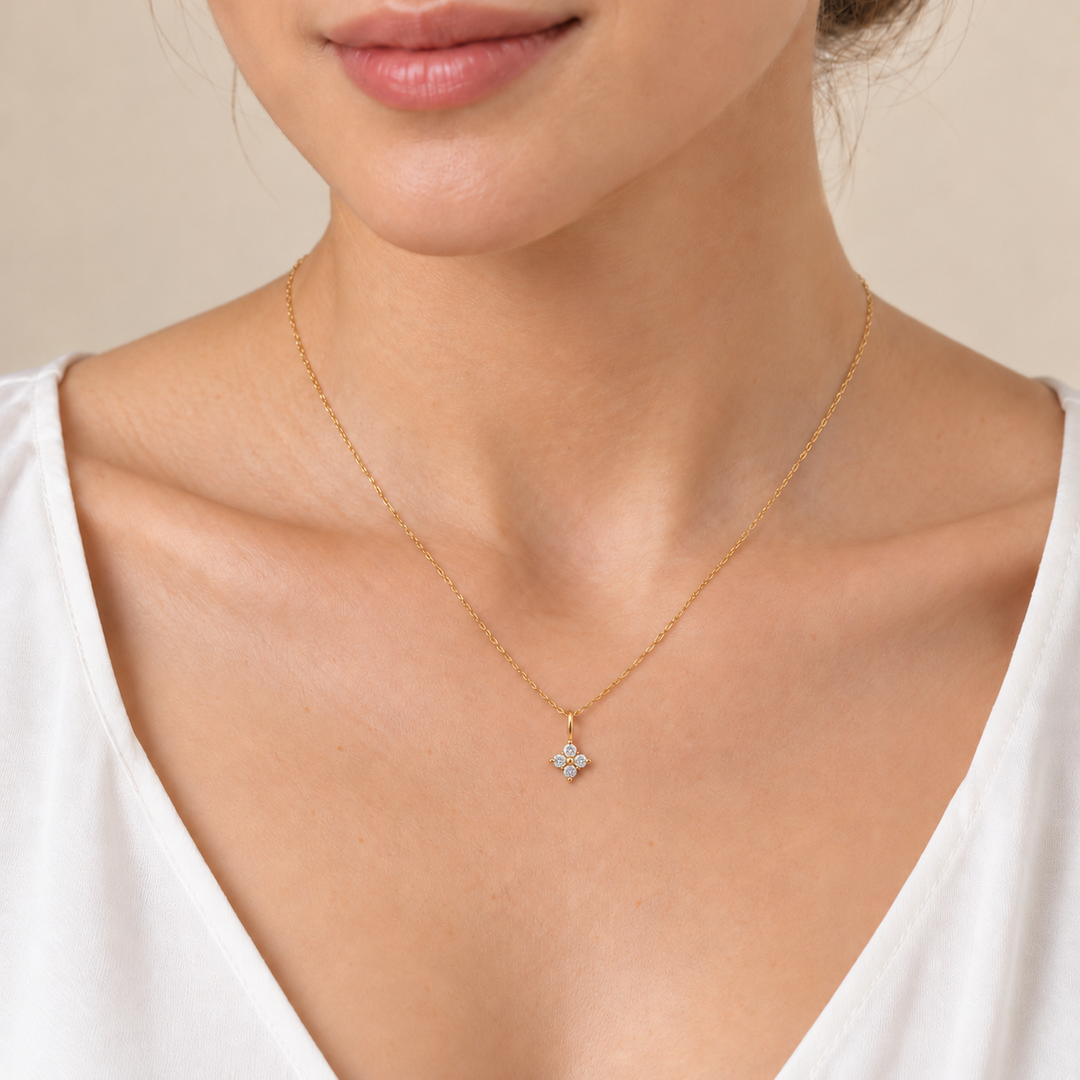 Delicate natural diamond flower pendant necklace in 14K yellow gold — worn on neck