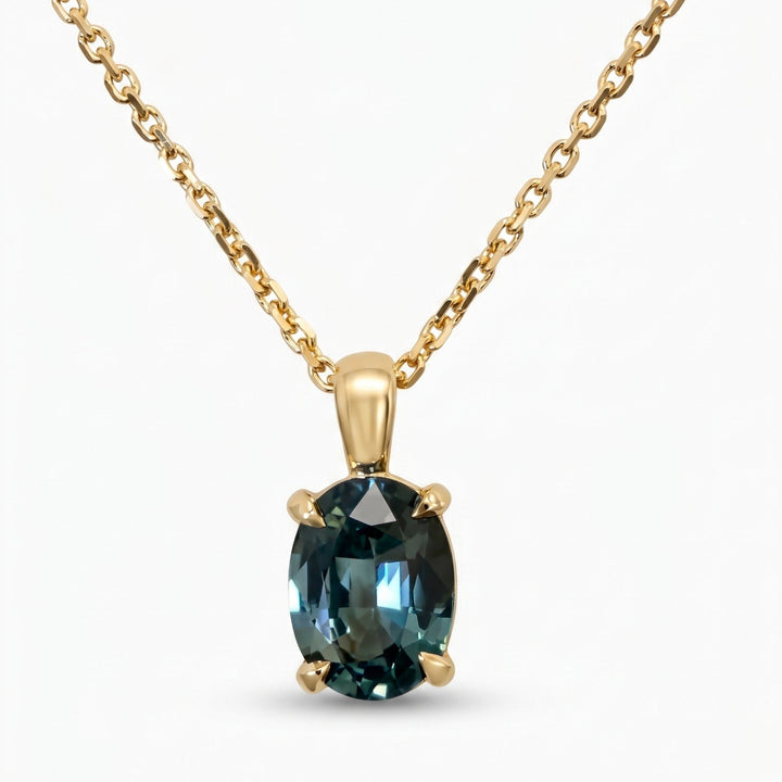 Oval natural teal sapphire pendant necklace in 14K yellow gold, front view