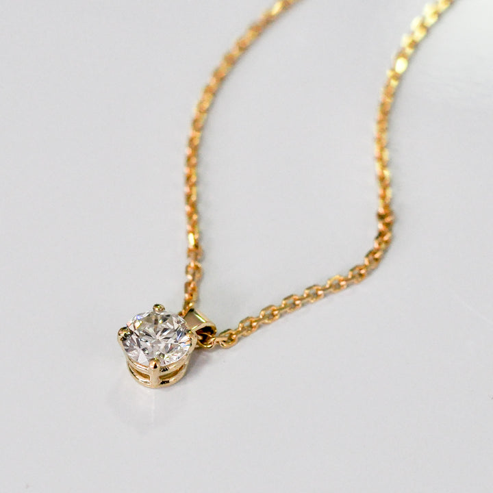 delicate low bail yellow gold solitaire diamond pendant