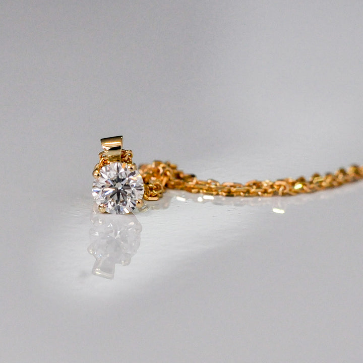 delicate low bail yellow gold solitaire diamond pendant