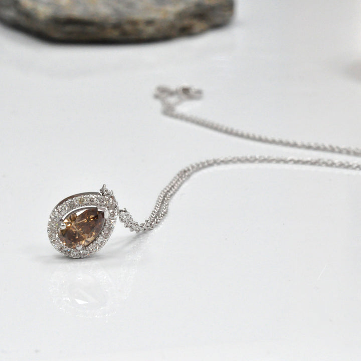 pear shape fancy brown and white diamonds halo pendant.