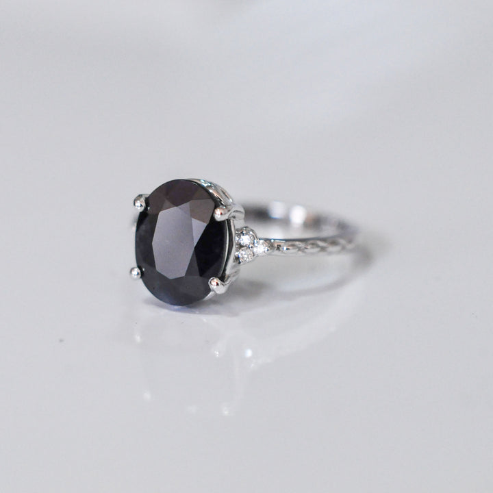 Oval Black Sapphire and side diamonds ring