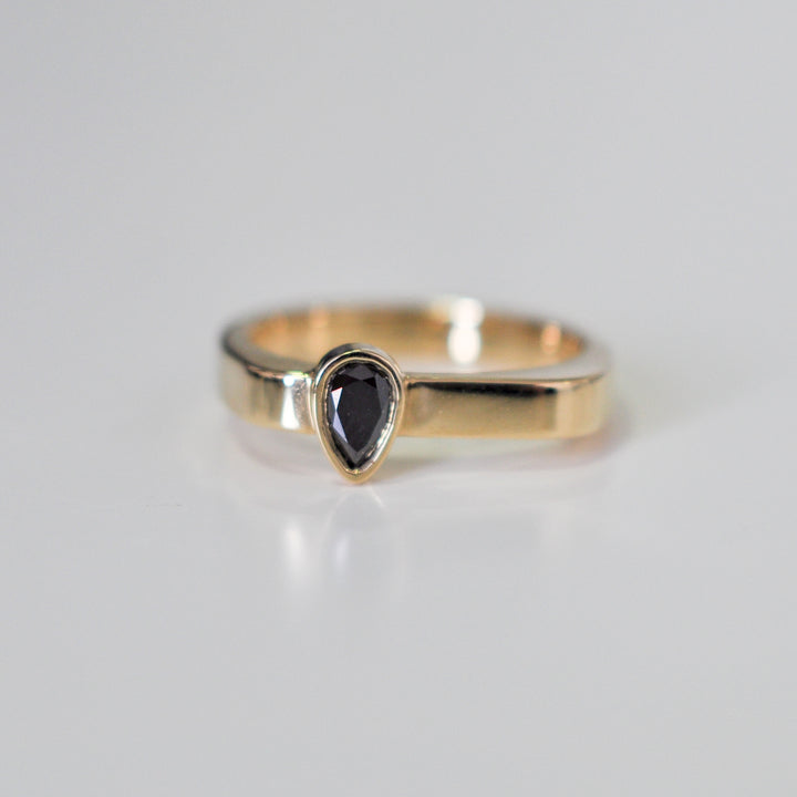 pear shape black diamond yellow gold ring