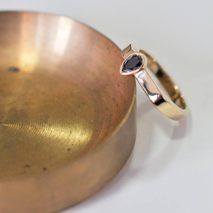 pear shape black diamond yellow gold ring