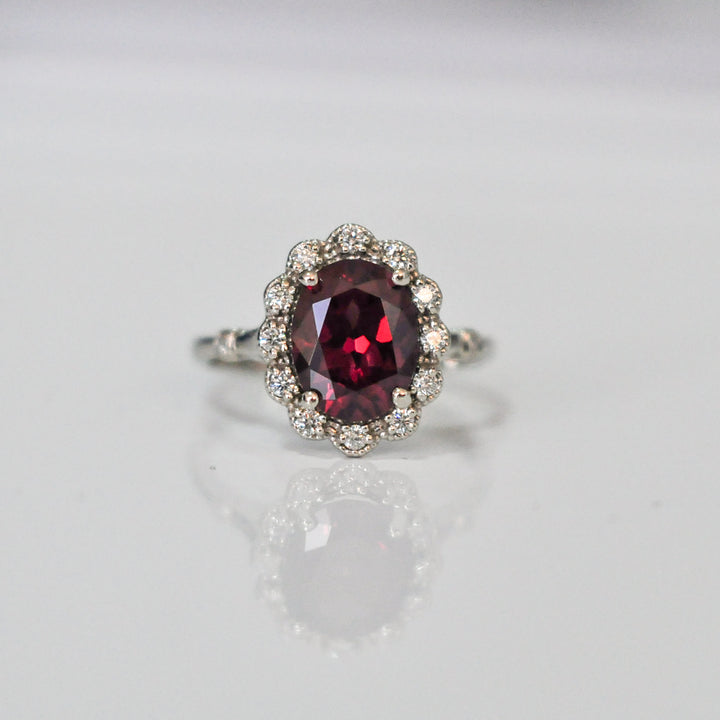 oval cut red garnet and diamonds ring