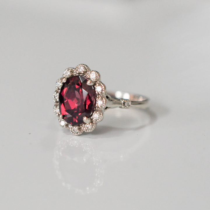 oval cut red garnet and diamonds ring