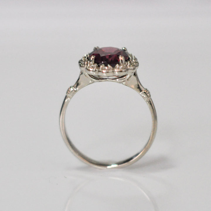 oval cut red garnet and diamonds ring