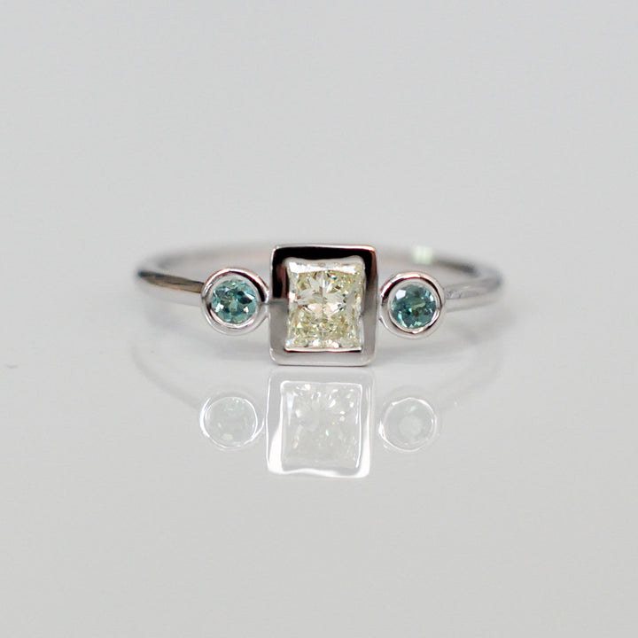 PRINCESS CUT diamond WITH two emeralds