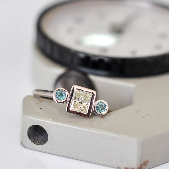 PRINCESS CUT diamond WITH two emeralds
