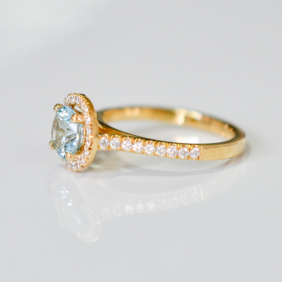 Aquamarine in yellow gold halo ring