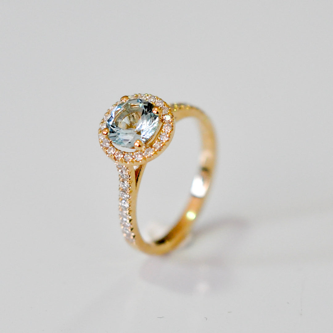 Aquamarine in yellow gold halo ring