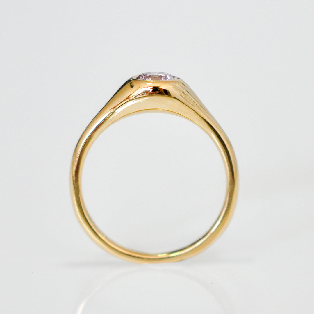 Faint pink diamond bezel set yellow gold ring