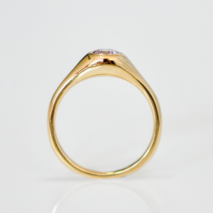 Faint pink diamond bezel set yellow gold ring