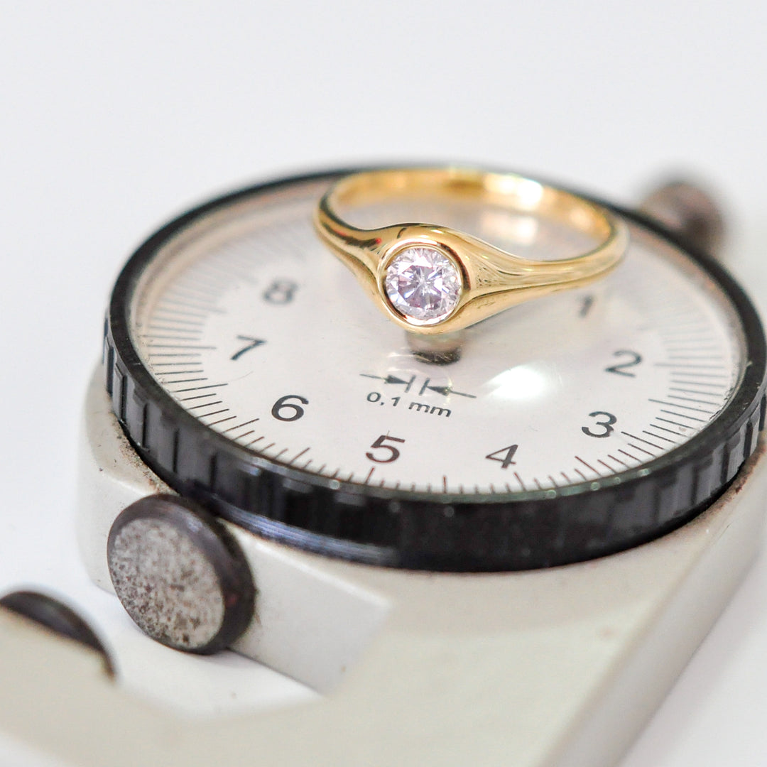 Faint pink diamond bezel set yellow gold ring