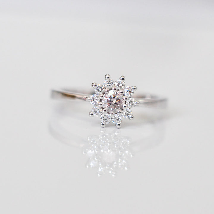 Faint pink center diamond with white diamonds HALO RING