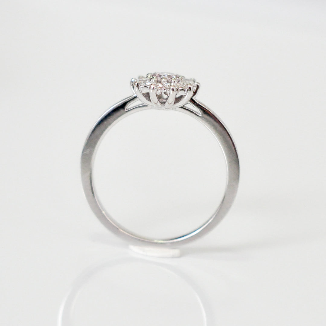 Faint pink center diamond with white diamonds HALO RING