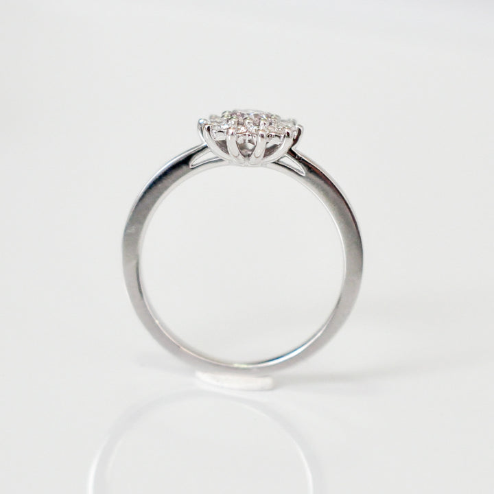 Faint pink center diamond with white diamonds HALO RING