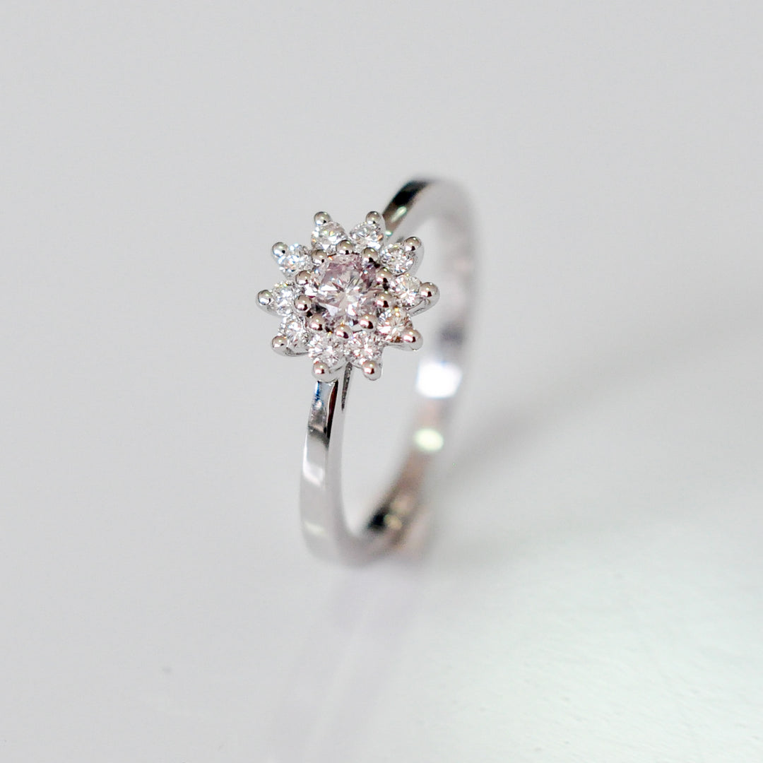 Faint pink center diamond with white diamonds HALO RING