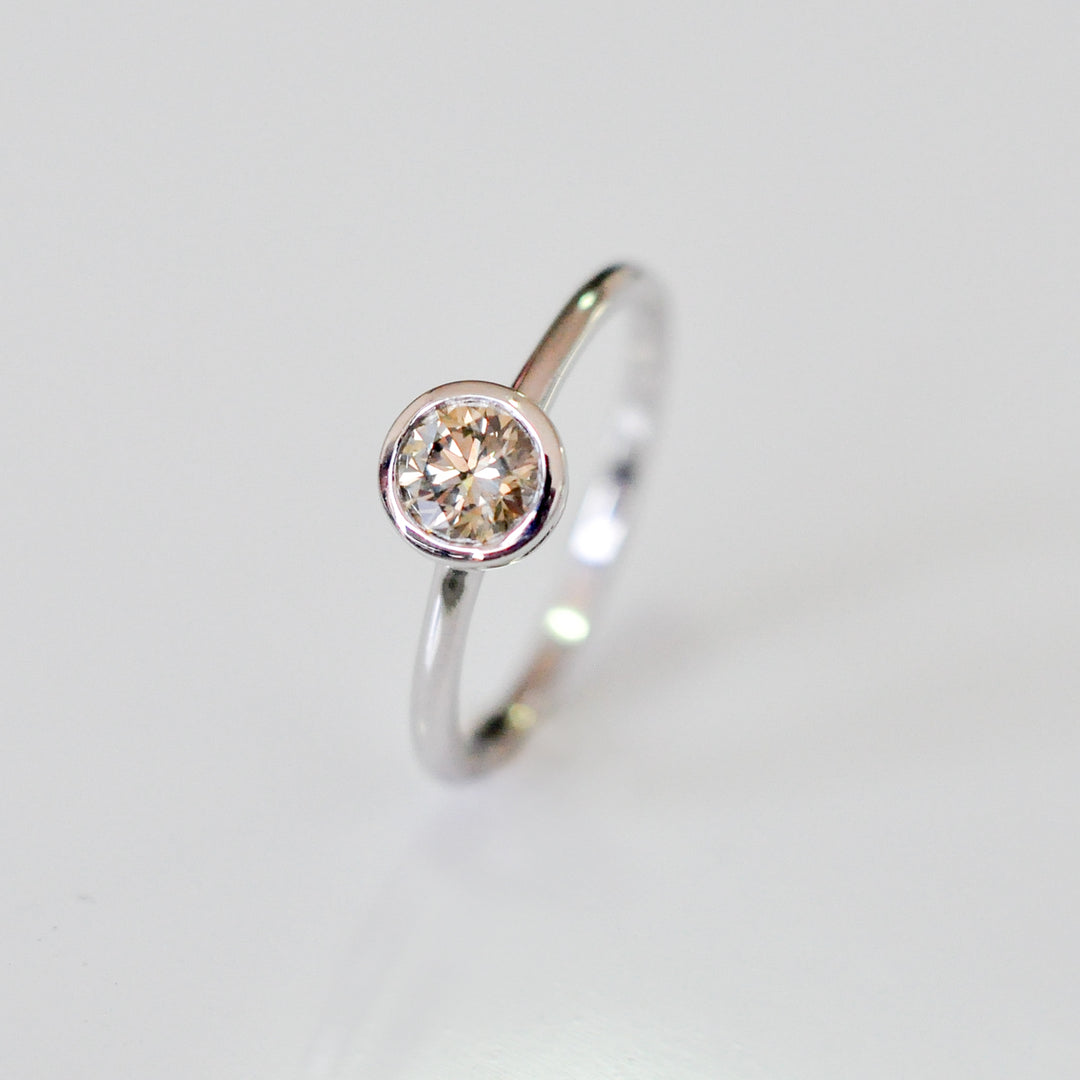 delicate bezel setting 0.5 carat diamond solitaire ring