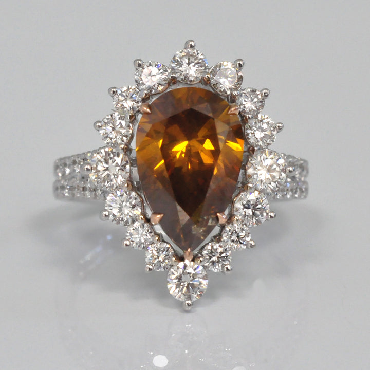 Pear shape fancy orangy brown diamond halo ring
