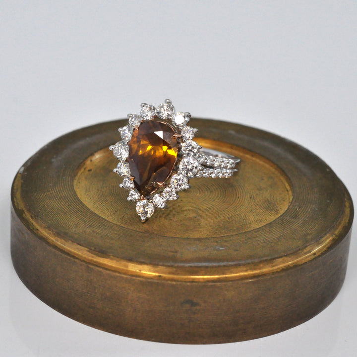 Pear shape fancy orangy brown diamond halo ring