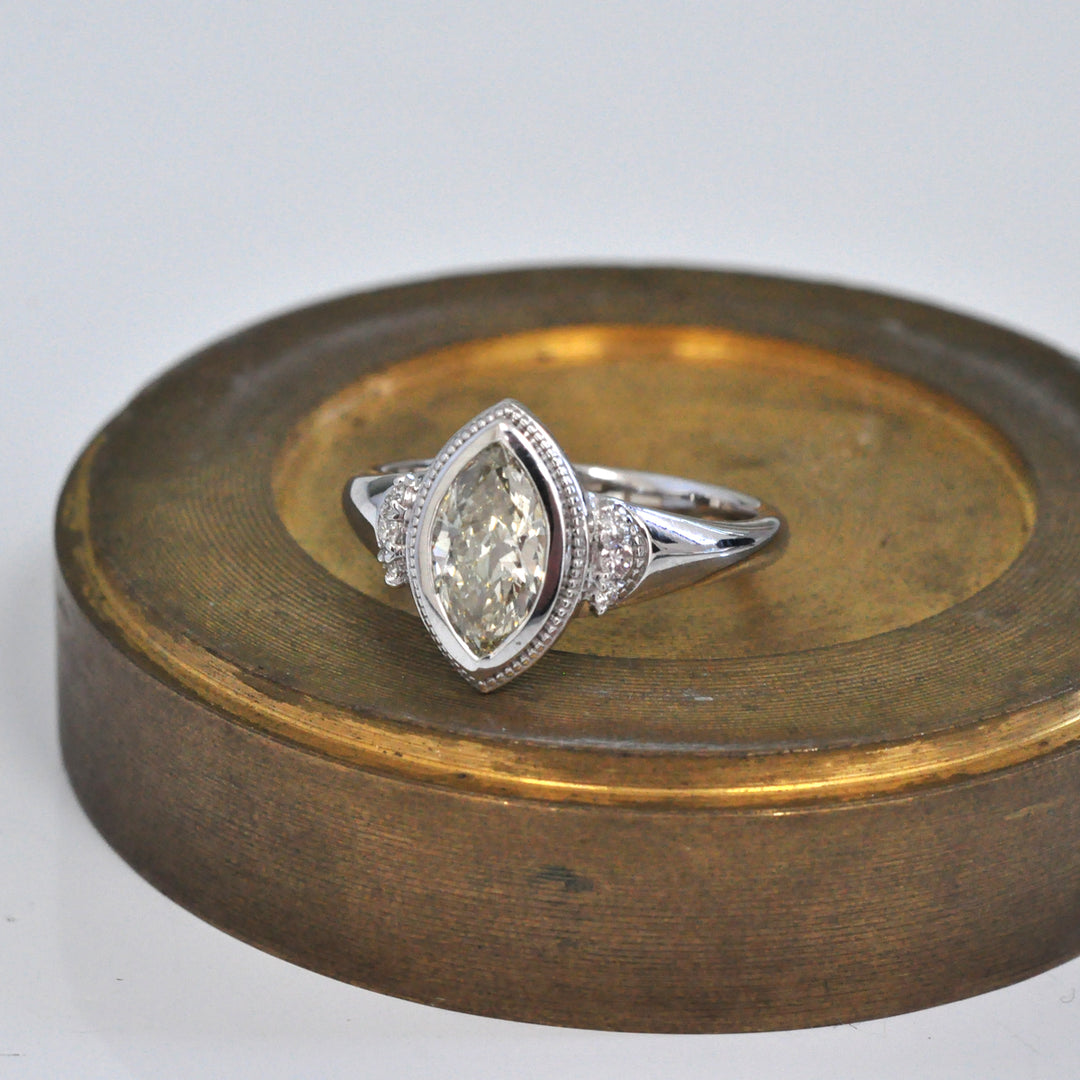 white gold bezel set marquise center diamond ring