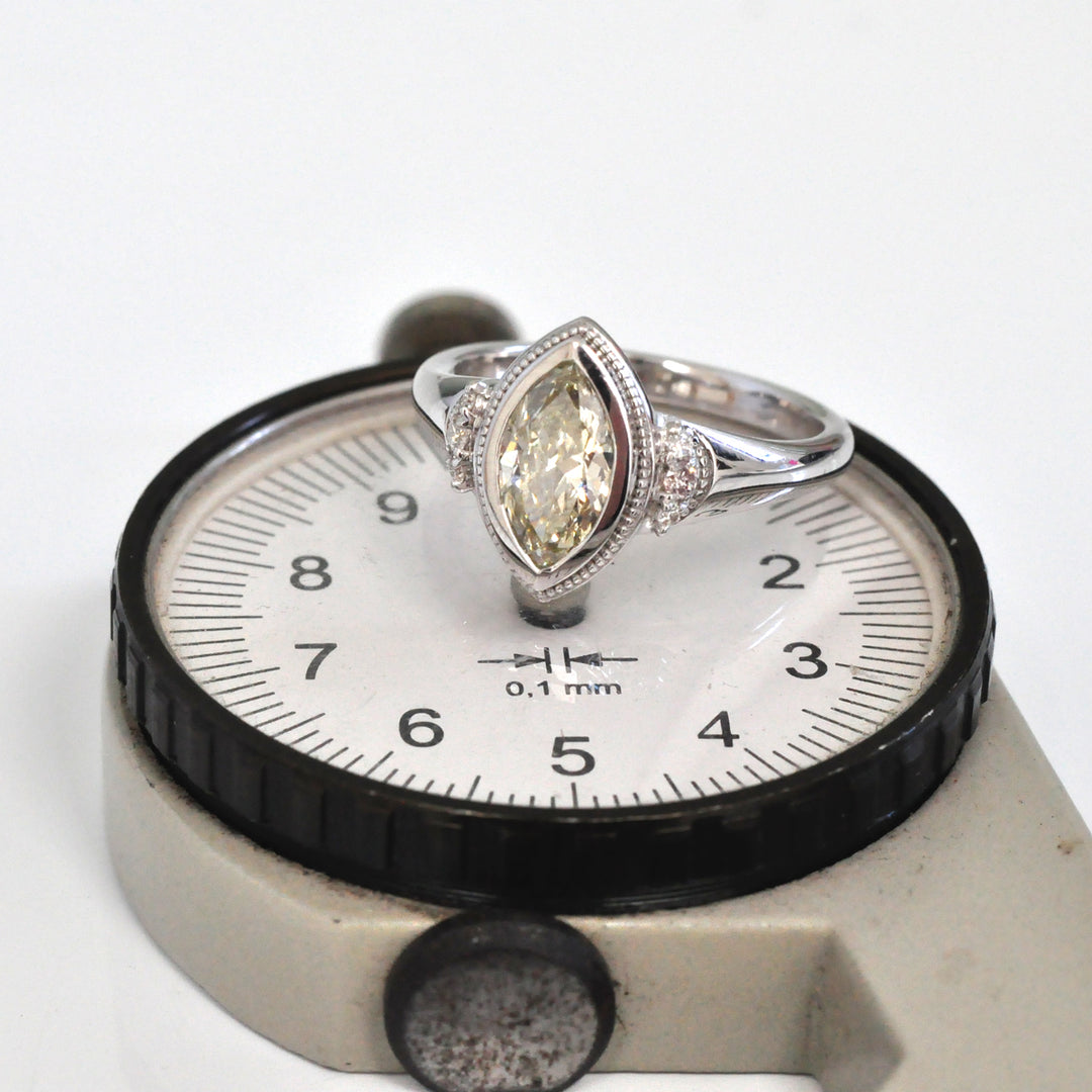 white gold bezel set marquise center diamond ring