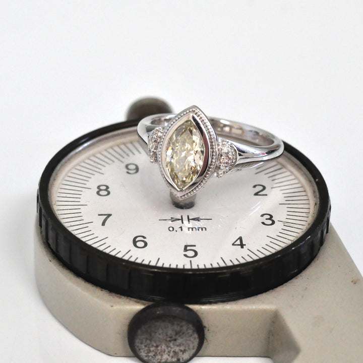 white gold bezel set marquise center diamond ring